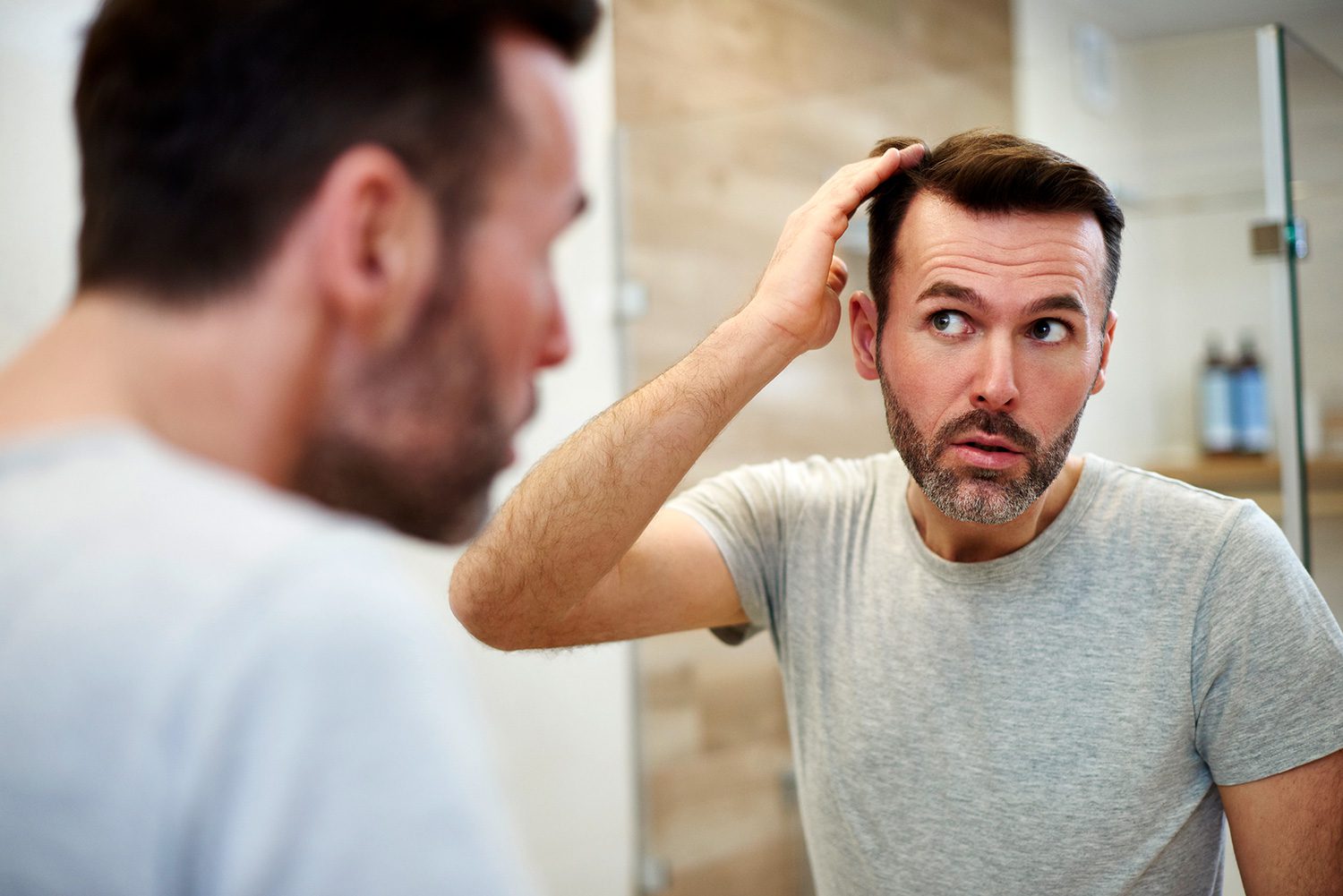 A man looking at himself in the mirror