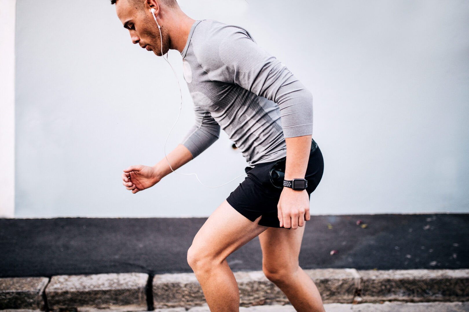 A man in shorts and a shirt is running