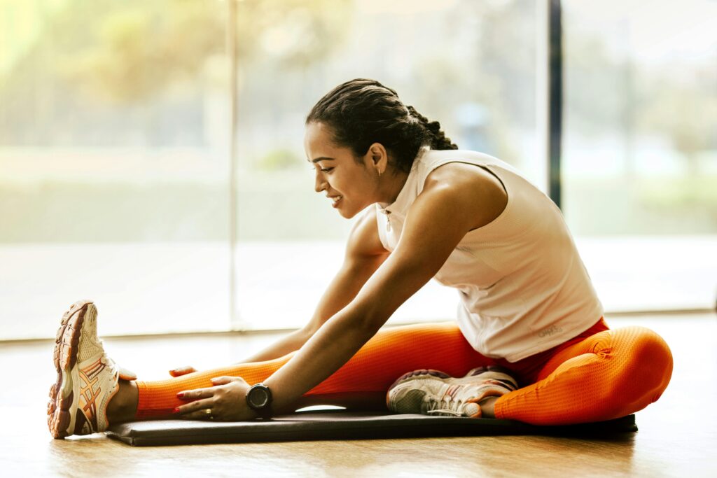 Exercise Guidelines for Platelet-Rich Plasma Therapy Regenerative Medicine & Orthopedics Miami Woman stretching legs on yoga mat.