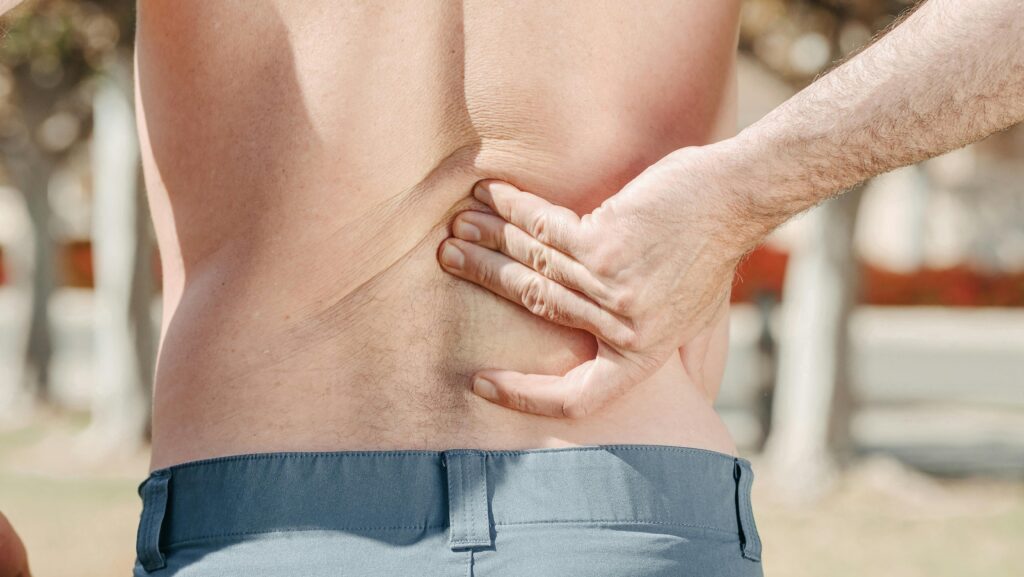 PRP Injections for Back Muscle Injuries in Sports Regenerative Medicine & Orthopedics Miami Man holding his lower back in pain.